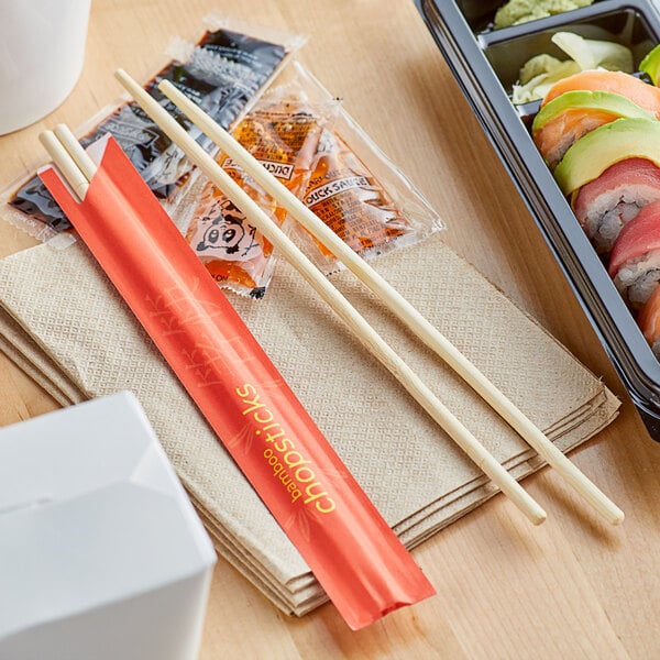 Emperor's Select disposable chopsticks next to sushi on a table.