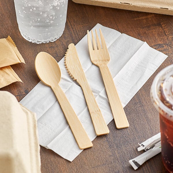A wrapped EcoChoice bamboo spoon and fork on a napkin.