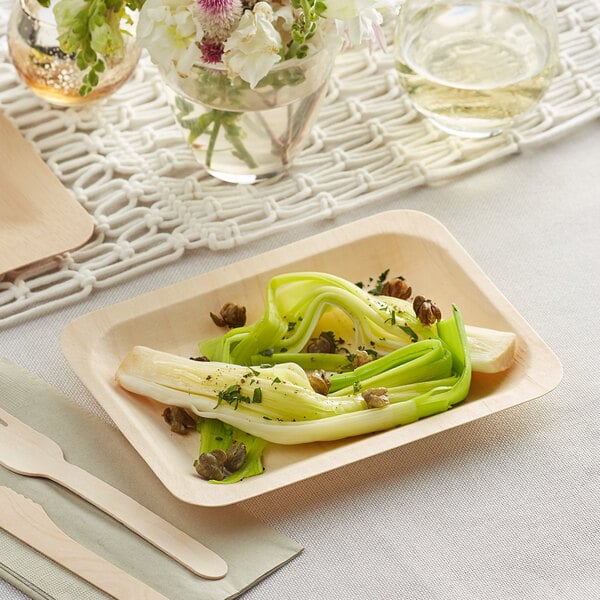 A TreeVive by EcoChoice compostable wooden rectangular plate with a sandwich on it.