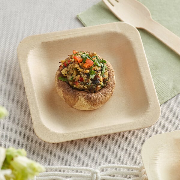 A TreeVive compostable wooden square plate with a mushroom, vegetables, and rice on it.