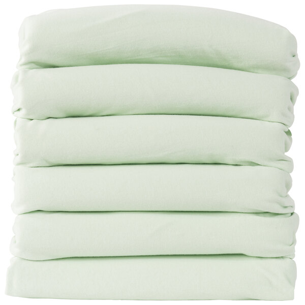 A stack of 6 mint green Foundations SafeFit fitted sheets.