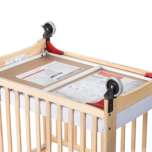 A wooden crib with Foundations First Responder Evacuation Frame and wheels.
