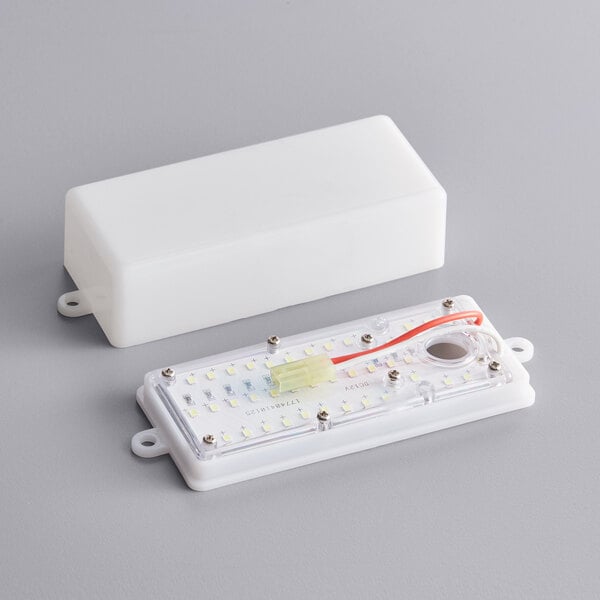 A white rectangular LED light panel with a wire.