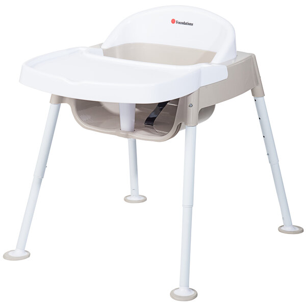 A Foundations Secure Sitter feeding chair with white legs.