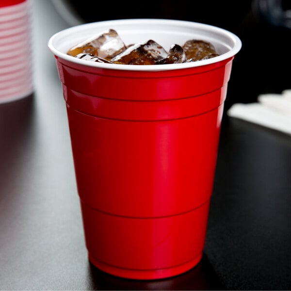 A Solo red plastic cup filled with ice on a white background.