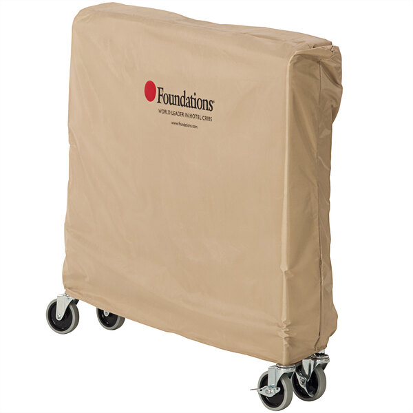 A tan Foundations crib cover on a wheeled cart.