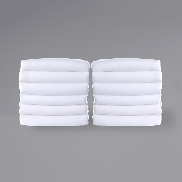 A stack of white Foundations SafeFit compact crib fitted sheets.
