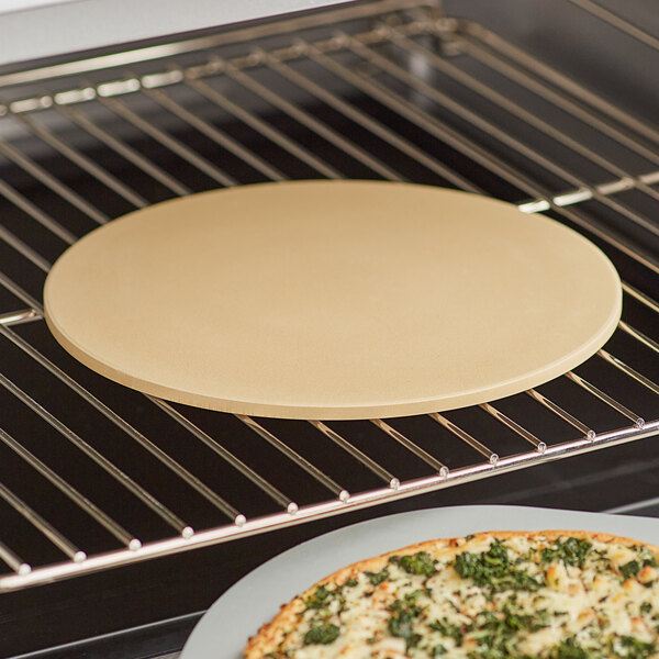 A pizza cooking on an Outset cordierite pizza stone in an oven.