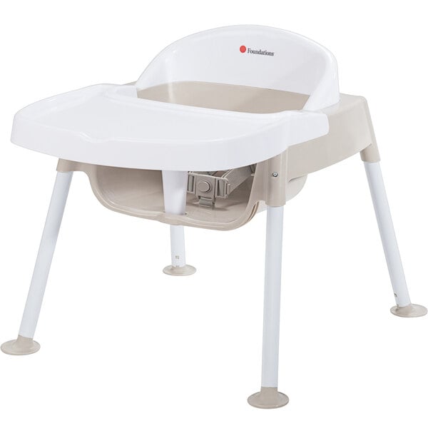 A white and tan Foundations Secure Sitter baby chair.