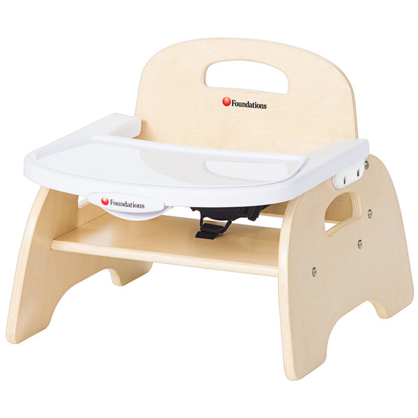 A wooden Foundations feeding chair with an EasyClean tray.