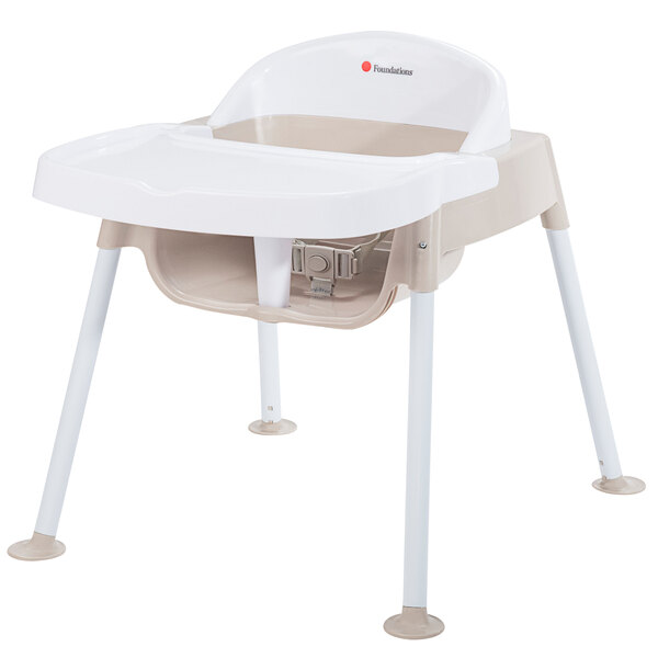 A white Foundations Secure Sitter feeding chair with legs.