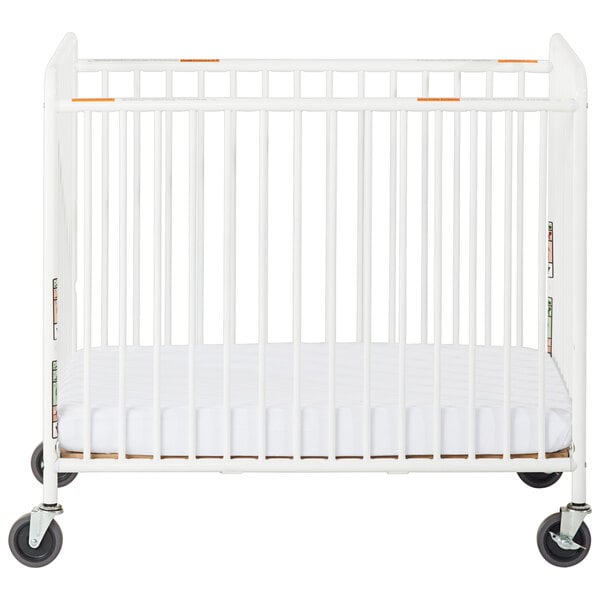 A white Foundations compact steel crib with slatted ends and wheels.