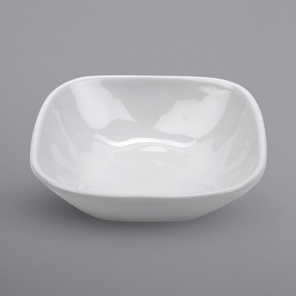 A white irregular square bowl with a curved edge.