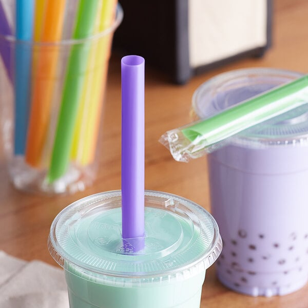 A plastic cup with a purple Choice neon boba straw in it.