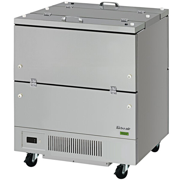 A large rectangular stainless steel Turbo Air milk cooler with wheels.