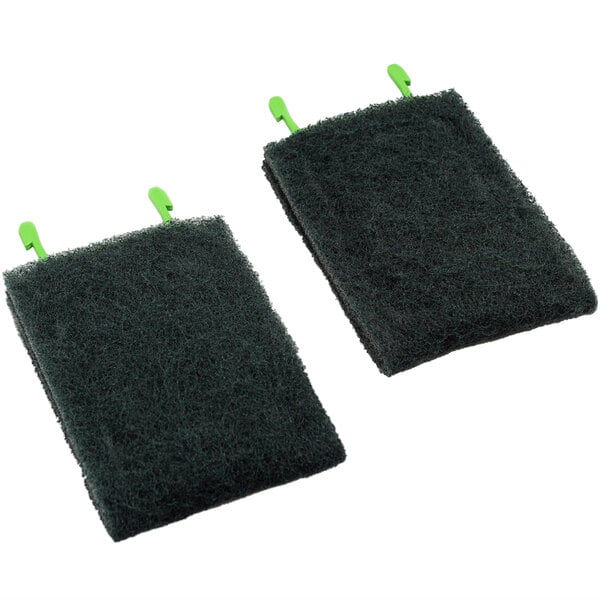 Two black sponges with green handles.