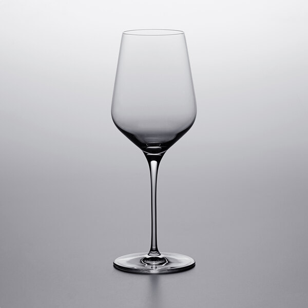 A Stolzle white wine glass on a table.