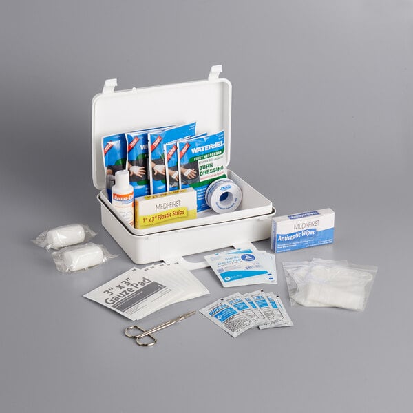 A Medique Deluxe Plastic Burn Kit with various first aid supplies inside.
