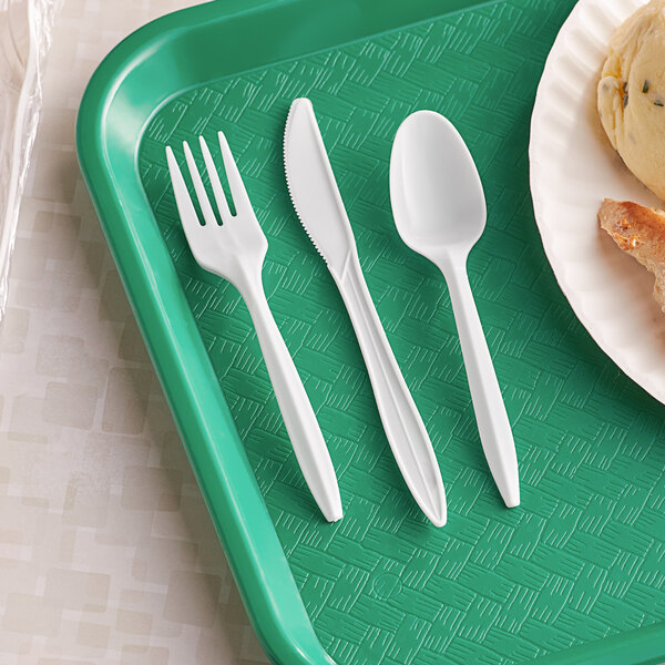 A green tray with white wrapped plastic fork, knife, and spoon.