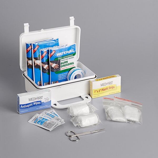 A Medique Basic Plastic Burn Kit with first aid supplies including bandages.