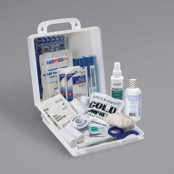 A Medique Chemical Burn Kit with various items in it including a white bottle.