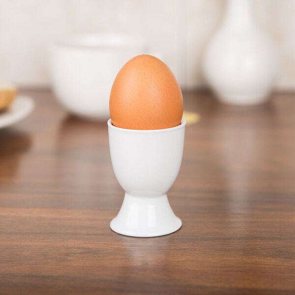 A white egg in a CAC white egg cup.