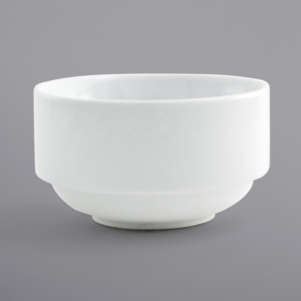 A Front of the House bright white porcelain bowl with a small rim on a gray surface.