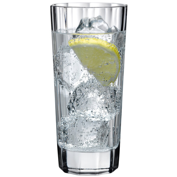 A Nude Hemingway highball glass of water with ice and a lemon slice.