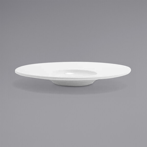 A close up of the front of a white Monaco porcelain plate with an extra wide rim.
