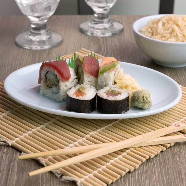 A Blue Jade melamine platter with sushi rolls and rice.