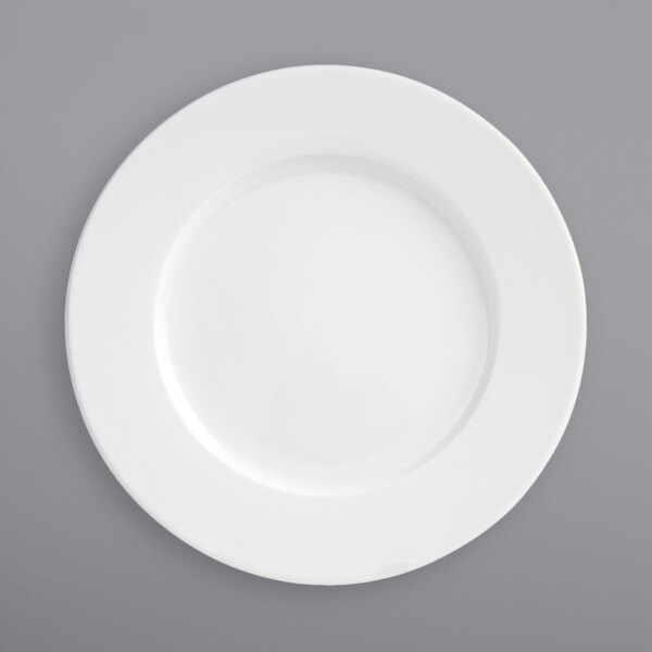 A close-up of a Front of the House Monaco bright white porcelain plate with a wide rim.