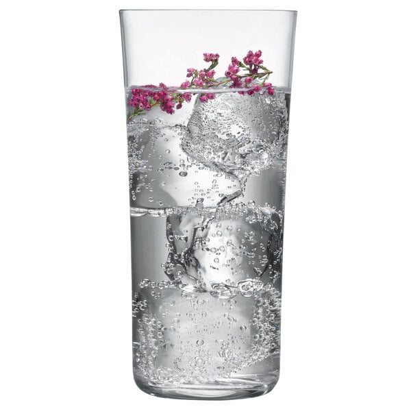 A Nude Savage highball glass with ice and flowers in water.