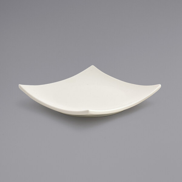 A Front of the House Catalyst Origami European White square porcelain plate with a curved edge.