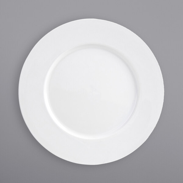 A close-up of a Front of the House Monaco bright white porcelain plate with a wide rim.