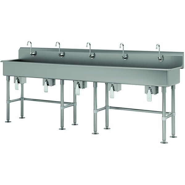 A large stainless steel multi-station hand sink with knee-operated faucets.