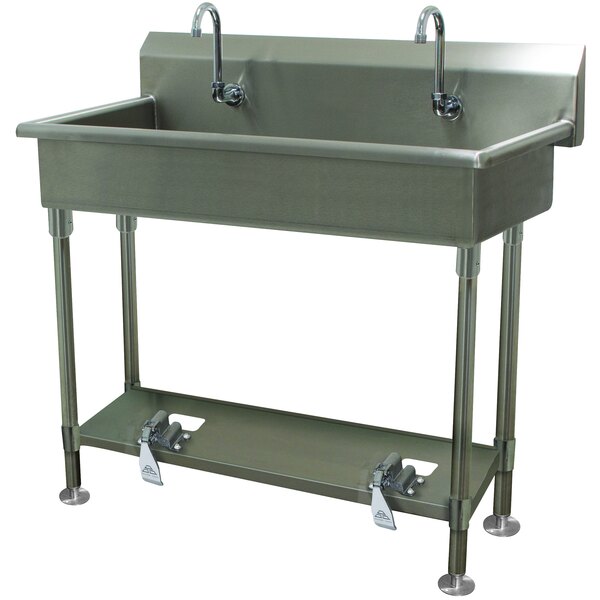 An Advance Tabco stainless steel multi-station hand sink with two toe-operated faucets.