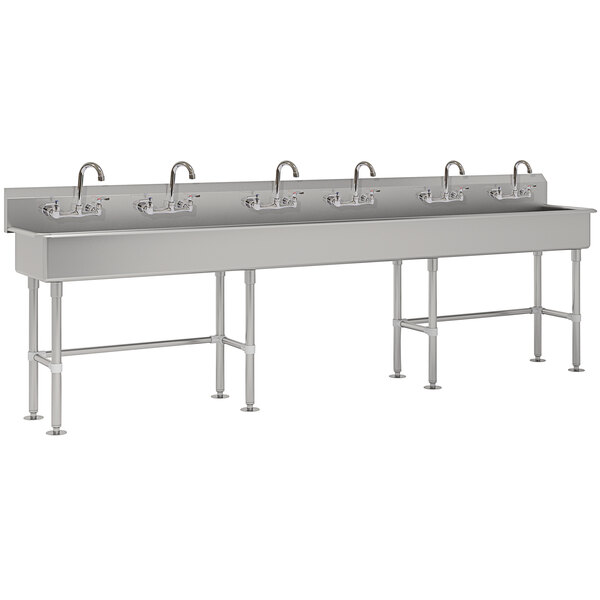 A long rectangular stainless steel Advance Tabco utility sink with three faucets on the side.