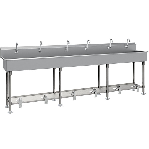 A large stainless steel Advance Tabco multi-station hand sink with 8" deep bowls, tubular legs, and 6 toe-operated faucets.