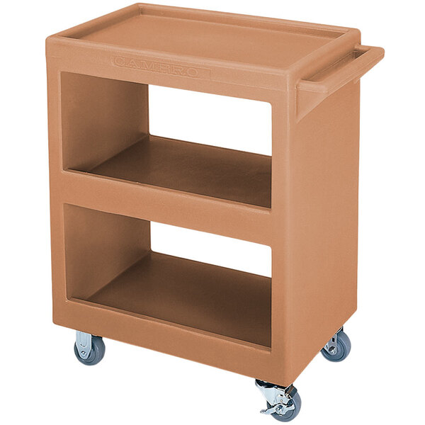 A coffee beige Cambro plastic service cart with three shelves and wheels.