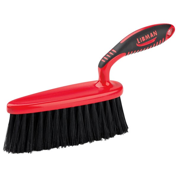 A red and black Libman Counter / Bench Brush with a handle.