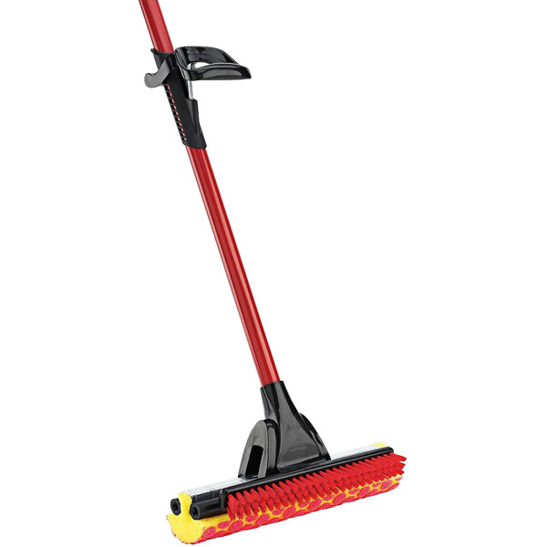 A Libman red and black roller mop with a long red handle and yellow scrub brush.