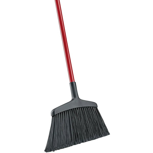 A close-up of a Libman commercial angle broom with a red handle and black and red bristles.