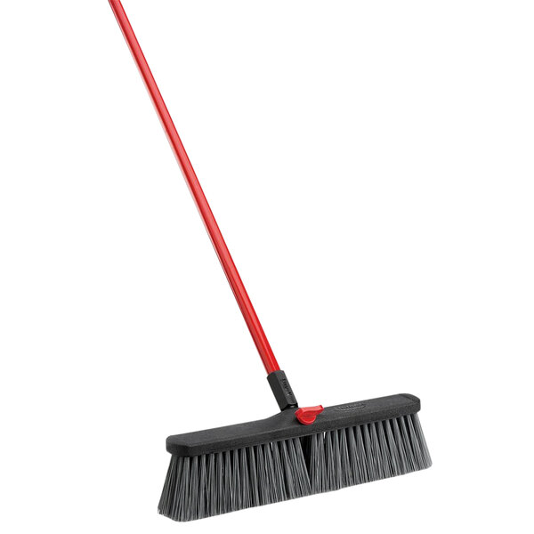 A black and red Libman rough surface push broom with a red handle.