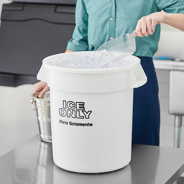 A person putting ice into a white Choice ice bucket.