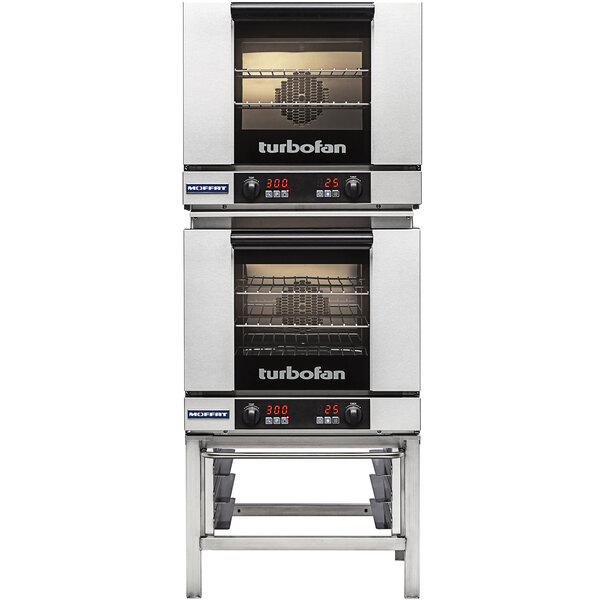 A Moffat stainless steel stand with two Moffat Turbofan electric convection ovens on it.