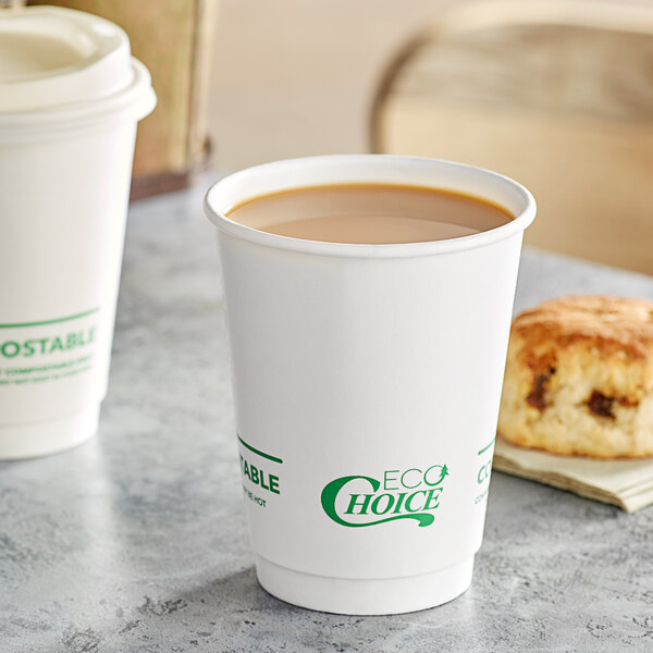 Two EcoChoice white paper hot cups filled with coffee on a table with a scone.