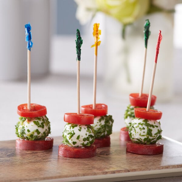 A tomato and cheese appetizer on a Choice Frill Club food pick.