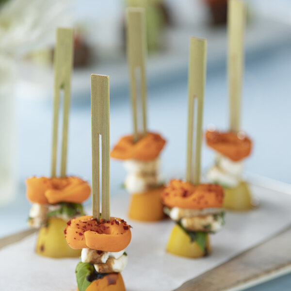 A tray of food on Bamboo by EcoChoice double prong skewers.