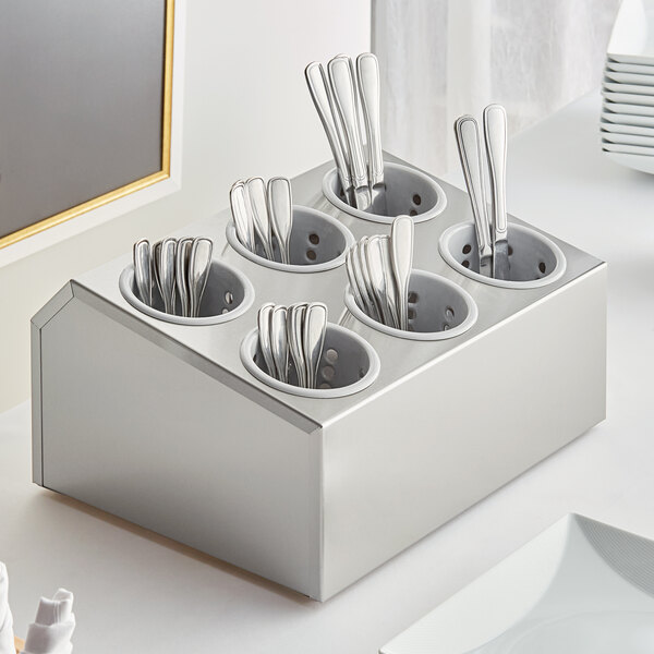A Choice stainless steel flatware organizer with gray perforated plastic cylinders holding silverware.