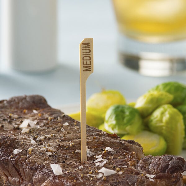 A piece of meat with a Bamboo by EcoChoice "Medium" Meat Marker in it.
